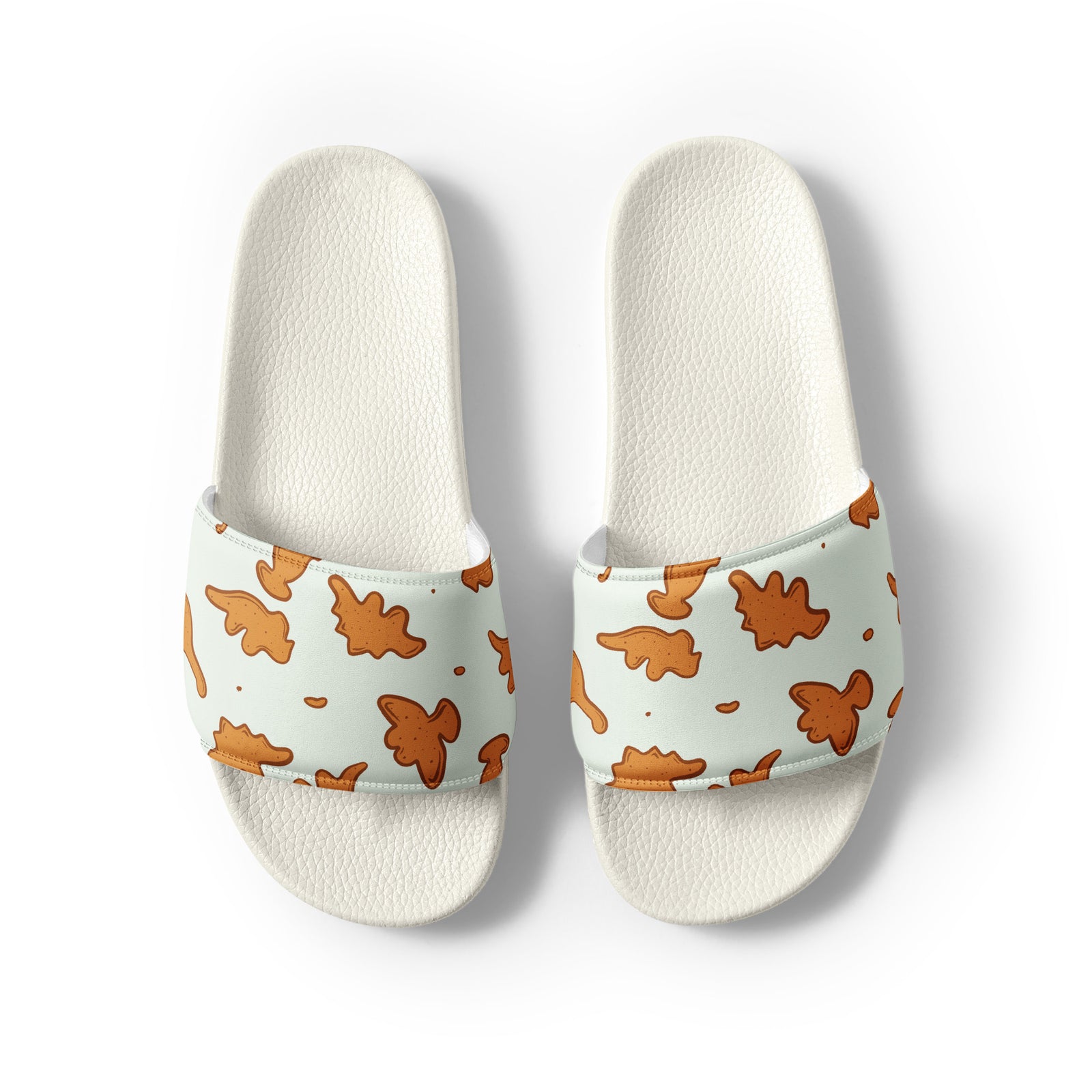 Dino Nuggies men's dinosaur slides with white soles, golden dino nugget print on a light mint strap