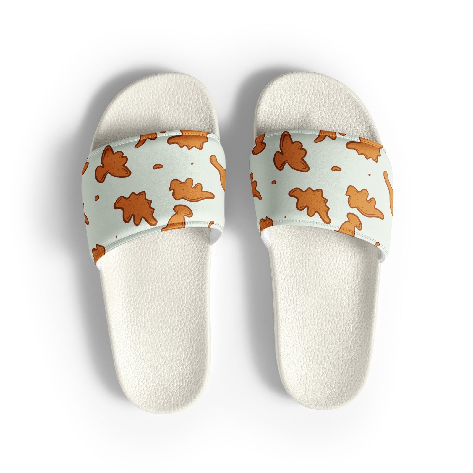 Dino Nuggies men's dinosaur slides with white soles, golden dino nugget print on a light mint strap
