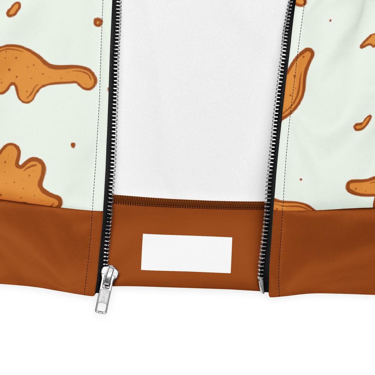 Close-up of the Dino Nuggies bomber jacket zipper, brown rib waistband and dino nugget print