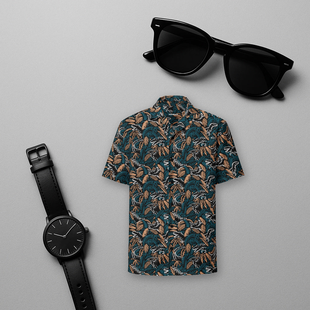 Dino Jungle dinosaur Hawaiian shirt flat lay on a light grey studio backdrop with black sunglasses and a black watch