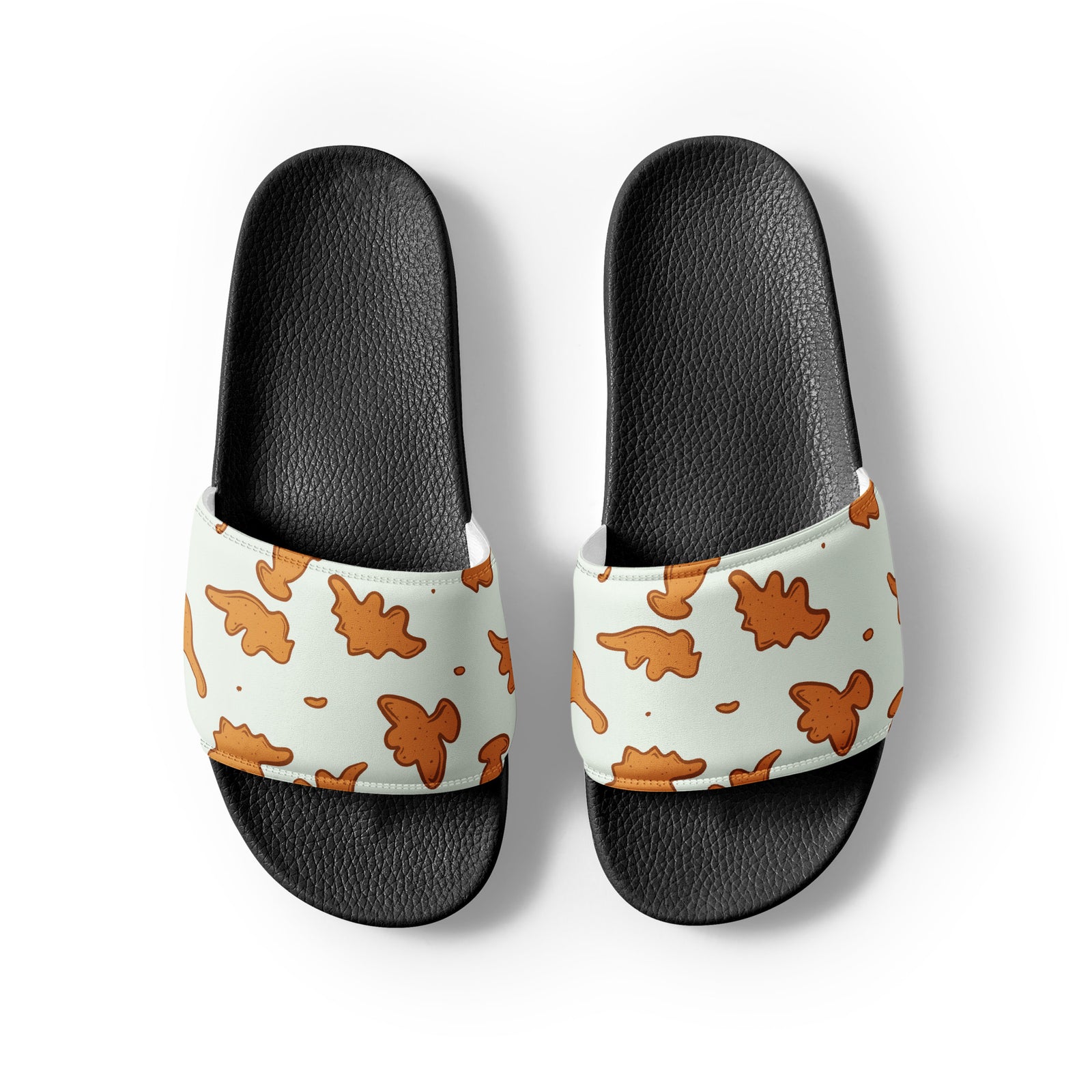Dino Nuggies dinosaur slides with black soles and a dino-shaped chicken nugget print strap