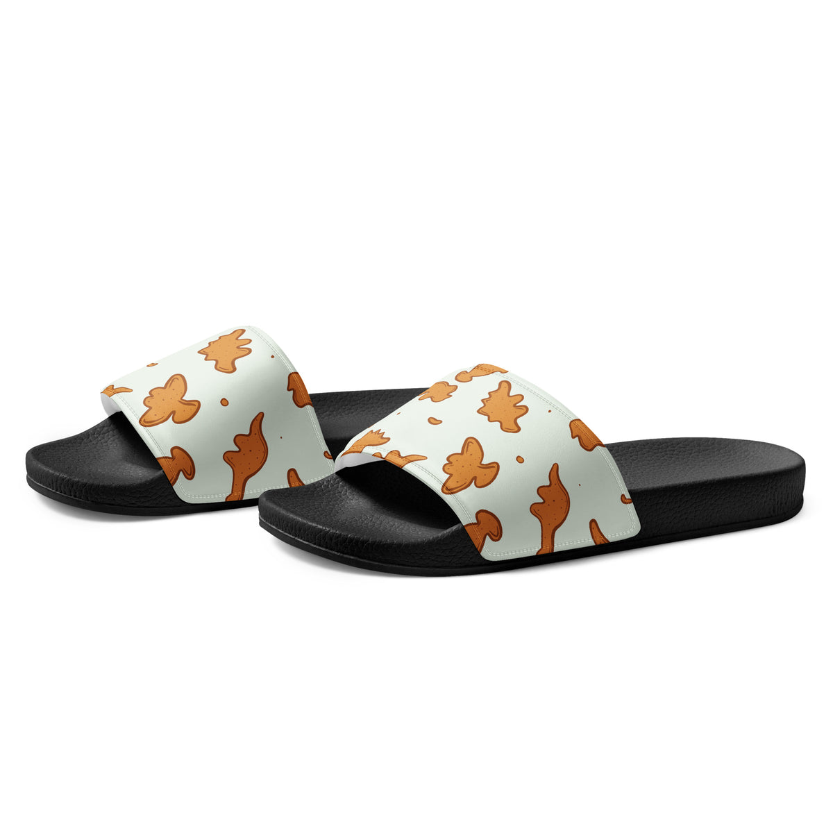 Angled view of Dino Nuggies dinosaur slides showing the cushioned printed strap