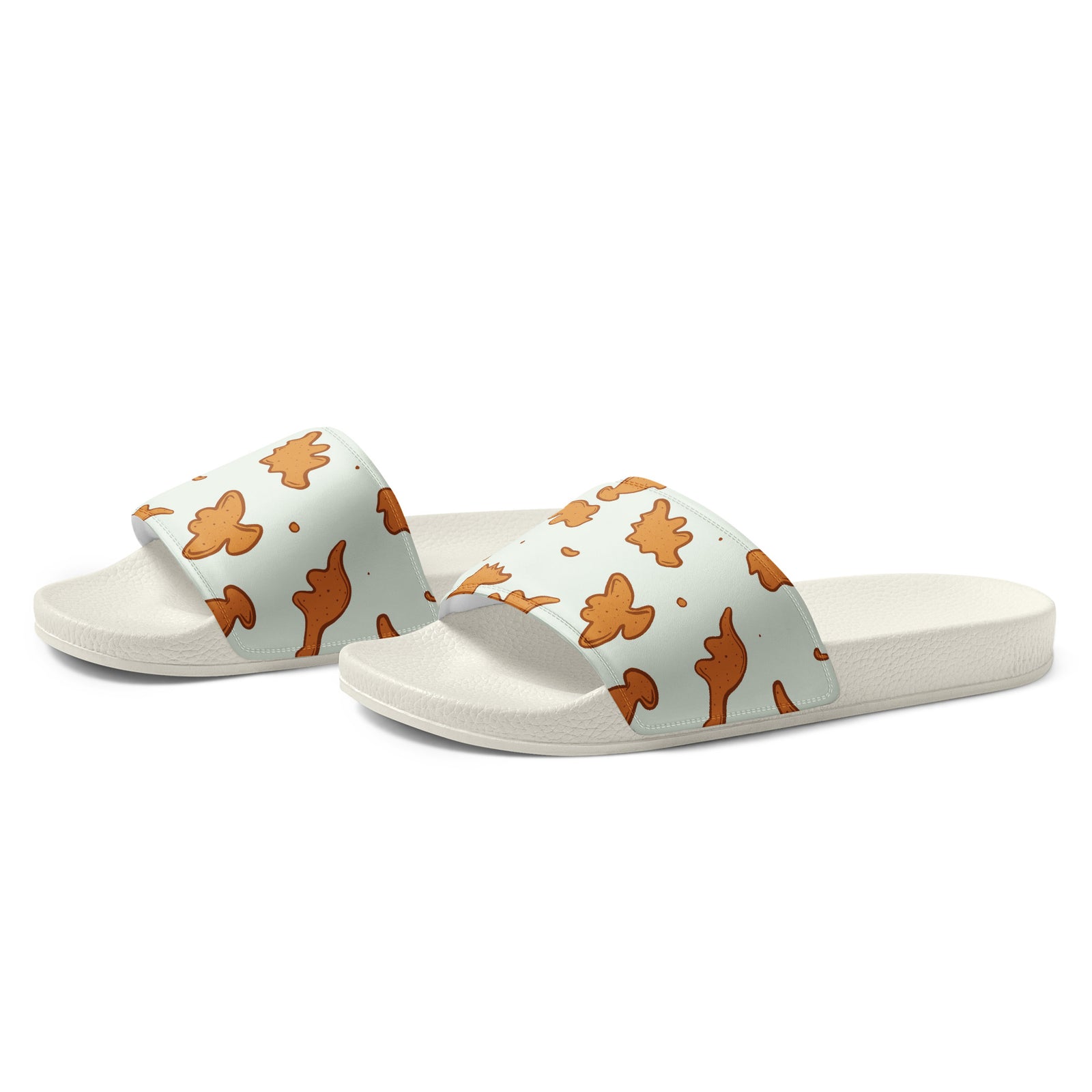 Angled view of Dino Nuggies dinosaur slides showing the cushioned printed strap