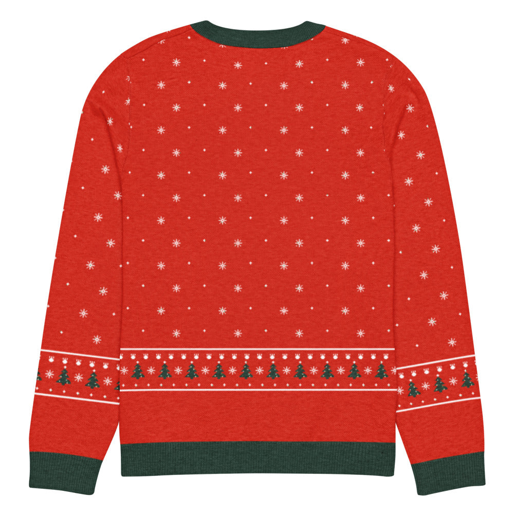 Back of the Santa Rex knitted dinosaur Christmas sweater with snowflakes and a tree and dino-footprint band above the green hem