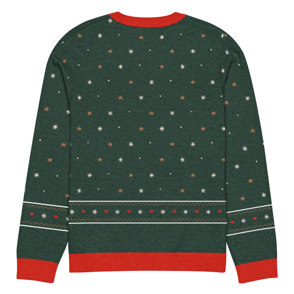 Back of the forest green Sleighceratops knitted Christmas sweater with snowflakes and a fair-isle snowflake, heart and zigzag band above the red hem