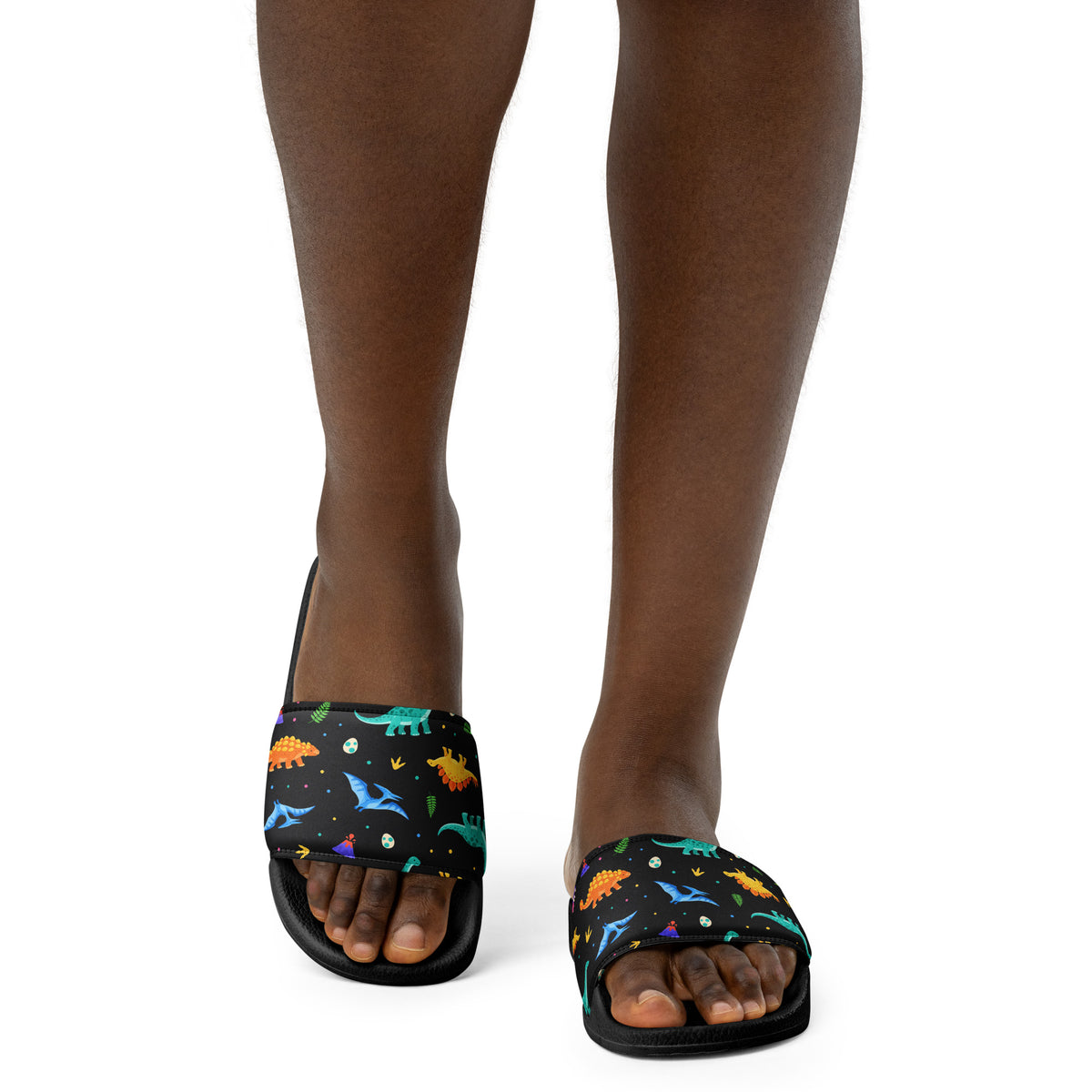 Woman wearing Bright Dinos dinosaur slides with a bright dinosaur pattern strap