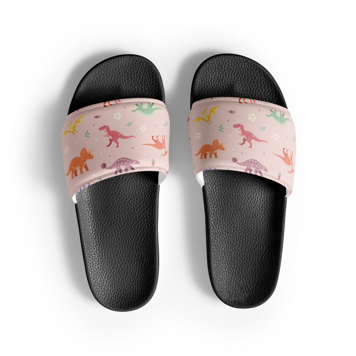 Blush Bloom Dinos dinosaur slides with black soles and a pink floral dinosaur print strap