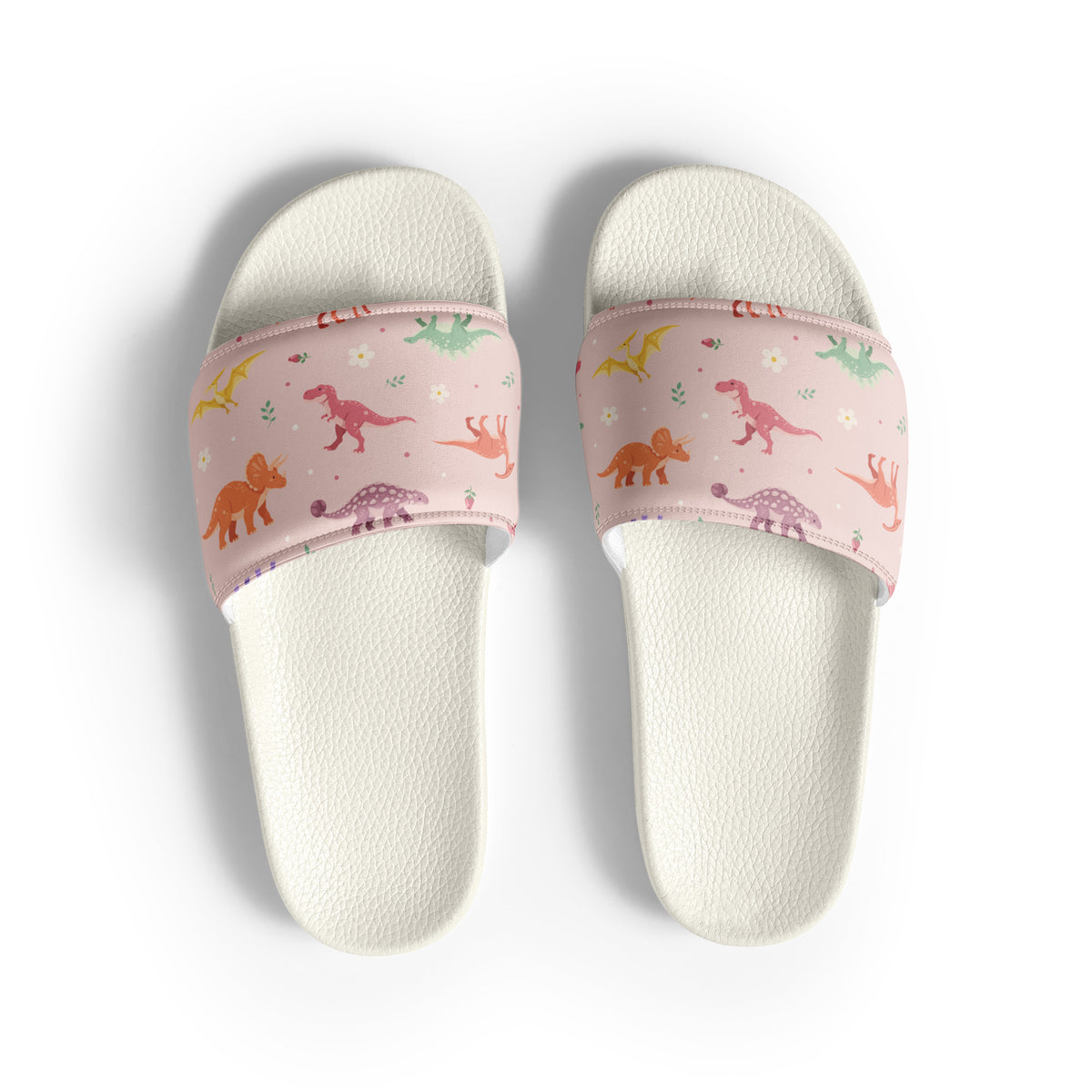 Blush Bloom Dinos women's dinosaur slides with white soles, pastel dinosaurs and flowers on a blush pink strap