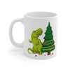 Christmas dinosaur mug where T-Rex is trying to figure out how to decorate the top half of his christmas tree with his tiny arms.